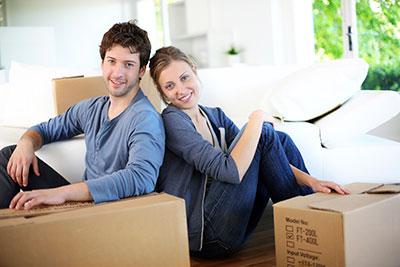 a couple sitting with boxes