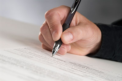a person writing on a paper